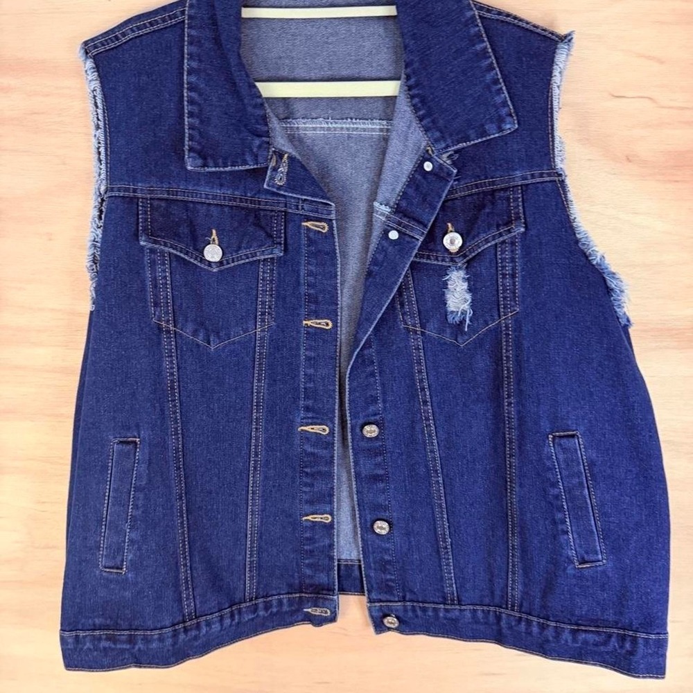 Denim vest with frayed hem and button-up front. Size: 3XL